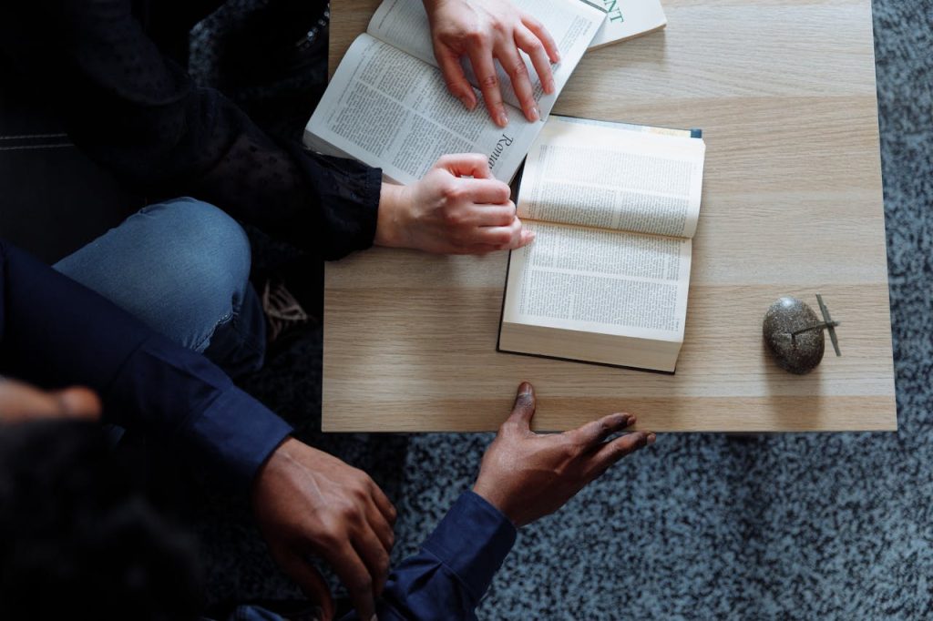 Crafting Captivating Headlines: Your awesome post title goes here Top view of diverse hands holding open books, creating an engaging reading session.